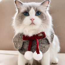 Load image into Gallery viewer, Colette Grey Cat Bib on Ragdoll Cat | Bouclé Cape with Red Bow and Pom Poms | MissyMoMo
